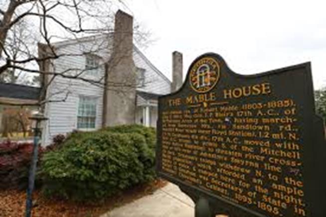 An image of a historic home with a placard in front yard in Mableton GA